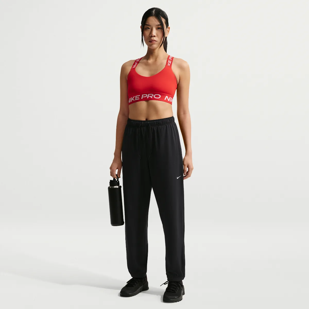 Nike Pro Dri-FIT Mid-Rise Full-Length Woven Pants by Nike