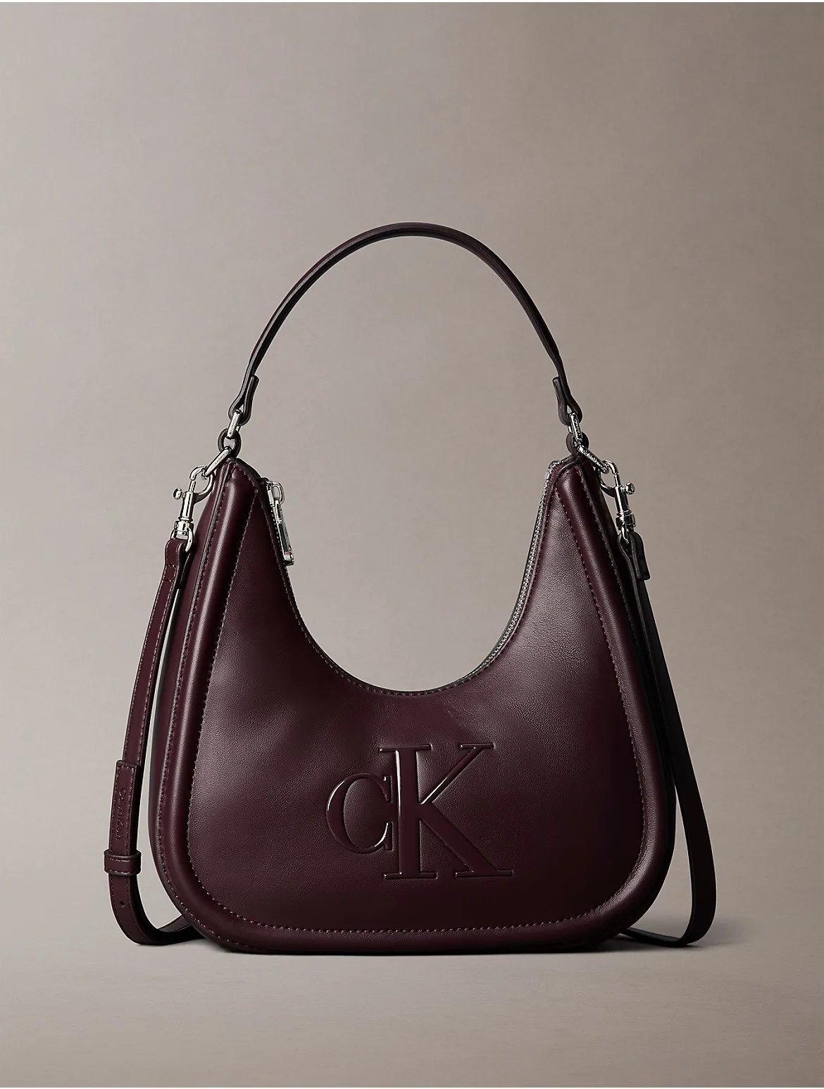 Embossed Monogram Crescent Bag by Calvin Klein