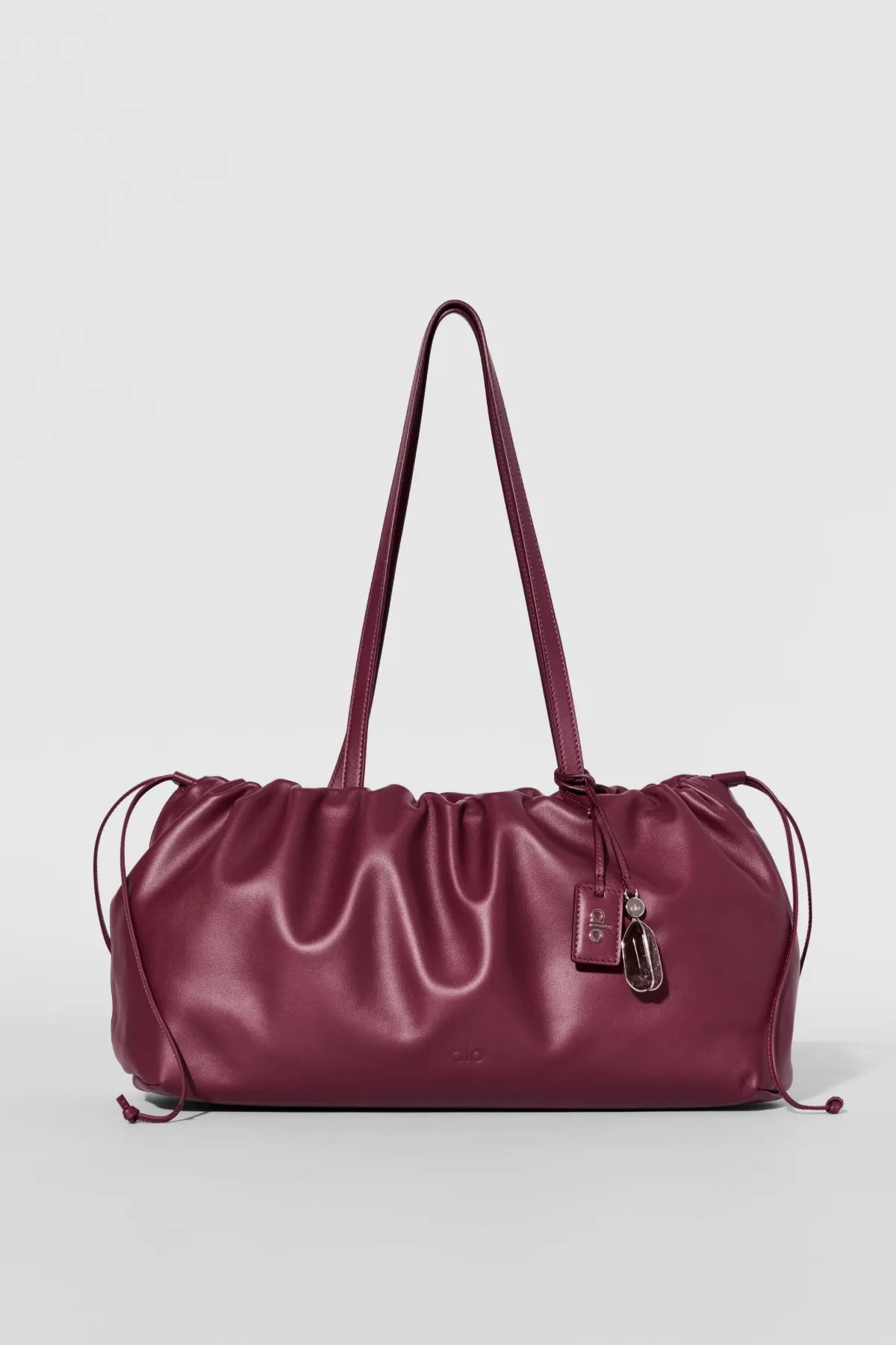 Unwind Cinch Bag in Bordeaux Leather by Alo