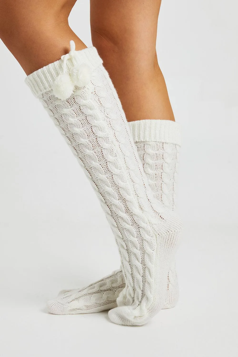 Knee High Cable Knit Pom Pom Cosy Socks by boohoo